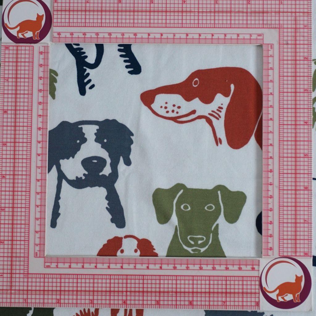 Baumwolljersey Hundeköpfe grün blau rostorange auf weiß